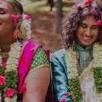 nonbinary Southeast Asian couple in traditional dress